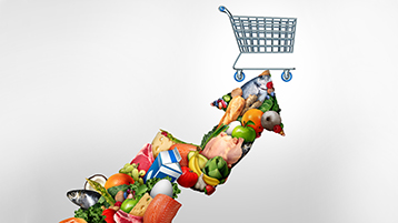 An arrow with food inside it, pointing to a shopping cart.